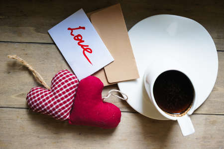 Cup of coffee, hearts and sweets on the chalkboard