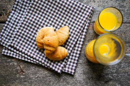 Helthy breakfast orange juice with croissantsの写真素材