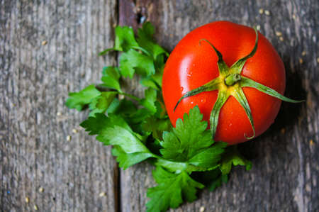 Fresh ripe tomatoes fruits on the wooden backgroundの写真素材