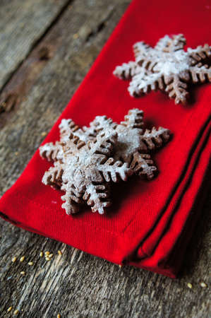 Christmas cookies snow flake shaped on a wooden backgroundの写真素材