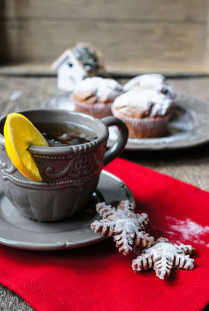 Chocolate muffins and cup of tea on the wooden backgroundの写真素材
