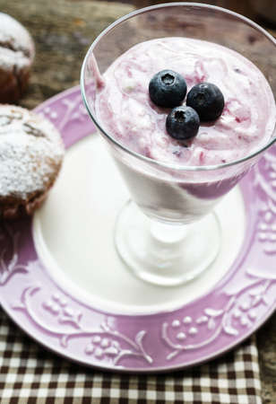 Natural yoghurt with fresh blueberries and muffinsの写真素材
