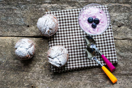 Natural yoghurt with fresh blueberries and muffinsの写真素材