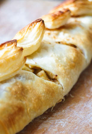 Viennese strudel with vanilla sauce on the old wooden tableの写真素材