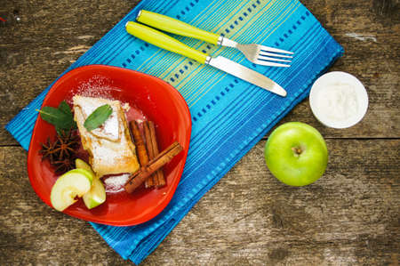 Viennese strudel with vanilla sauce on the old wooden tableの写真素材