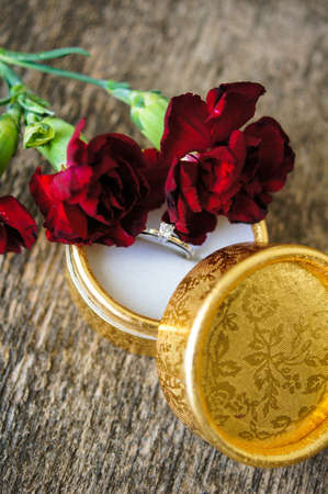 Red cloves with letter for valentine's day on the wooden backgroundの写真素材