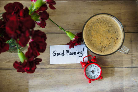 Cup of coffee with red cloves flowers for Valentine's dayの写真素材