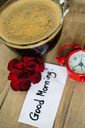 Cup of coffee with red cloves flowers for Valentine's day