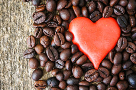 Cup of coffee and red cloves flowers in a vase with good morning noteの写真素材