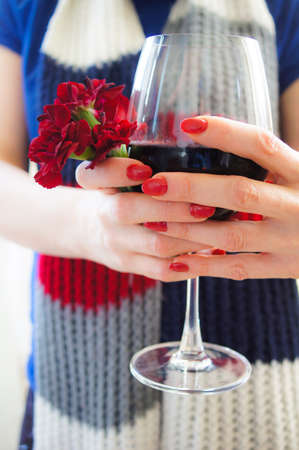 Beautiful woman in stripped scarf with red wine glassの写真素材