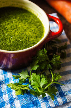 Spinach cream soup on the wooden table. Selective focusの写真素材