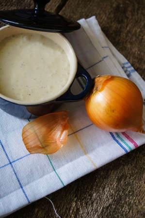 Traditional french onion cream soup on the wooden tableの写真素材