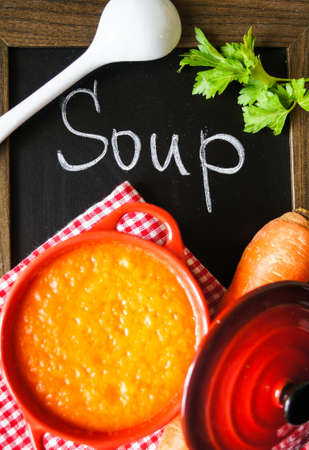 Healthy dinner, carrot cream soup on the old wooden tableの写真素材