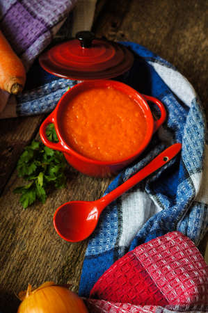 Healthy dinner, carrot cream soup on the old wooden tableの写真素材