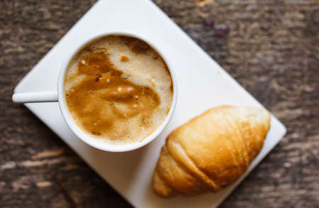 Red cup of coffee with coffee beans and spices cinnamon and anise starの写真素材