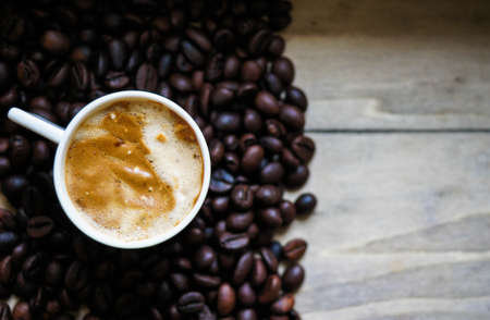 Red cup of coffee with coffee beans and spices cinnamon and anise starの写真素材