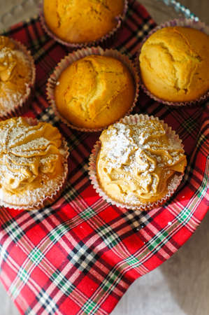 Sweet muffins and cup of black tea on the table with napkinの写真素材