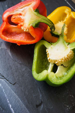 Fresh vegetables, different colors of bell pepper on the wooden backgroundの写真素材