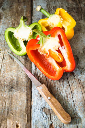 Fresh vegetables, different colors of bell pepper on the wooden backgroundの写真素材