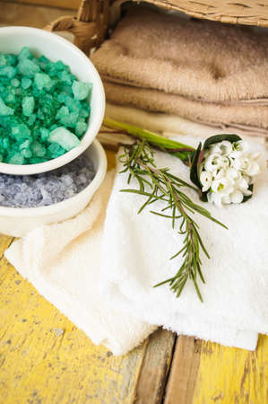 Green herbal spa with few kinds of sea salt, rosemary and snowdrop flowersの写真素材
