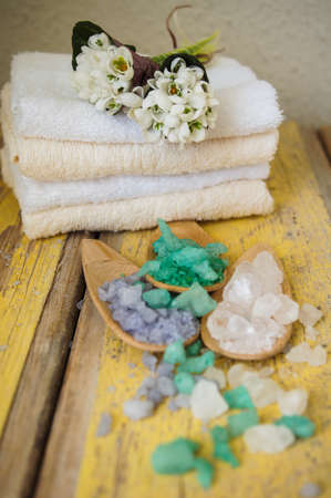 Green herbal spa with few kinds of sea salt, rosemary and snowdrop flowersの写真素材