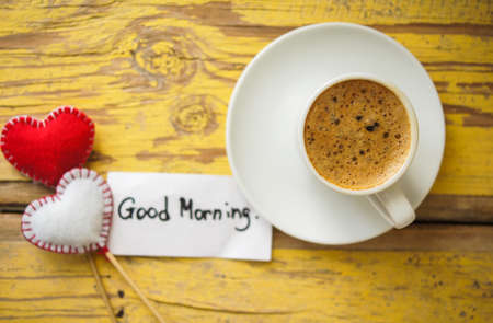 Cup of black coffee and first spring snowdrop flowers on the old tableの写真素材