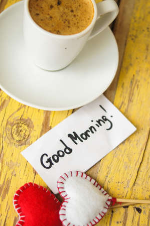 Cup of black coffee and first spring snowdrop flowers on the old tableの写真素材