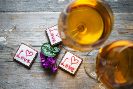 Glasses of white wine and cookies for Valentine's Dayの写真素材