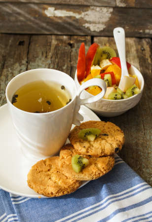 Cup of tea and bowl with fruit saladの写真素材