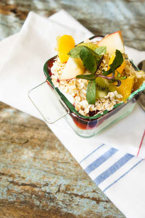 Oat flakes and fruit salad on wooden table. Selective focus,の写真素材