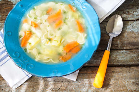 vegetable soup in a cup on a wooden rustic backgroundの写真素材