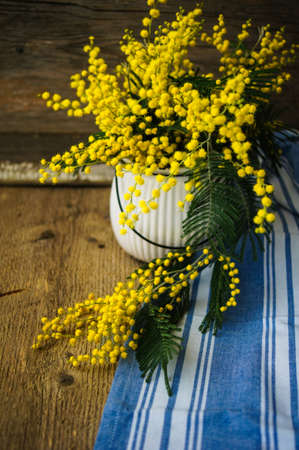 Easter time, yellow mimosa flowers on the old tableの写真素材