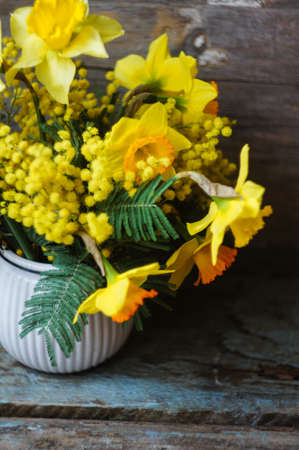 Easter time, spring flowers and cup of tea on the old wooden tableの写真素材