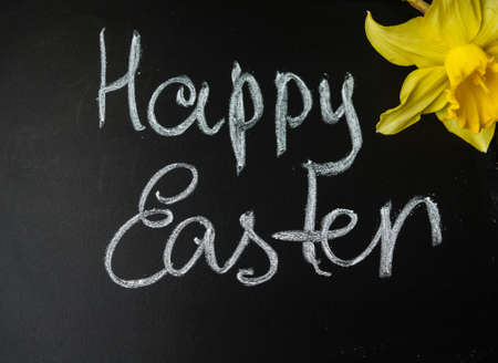 Easter time, spring flowers and cup of tea on the old wooden tableの写真素材