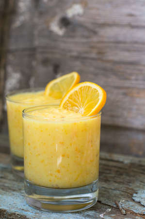 Healthy food, lemon smoothie with lemon fruits on the wooden backgroundの写真素材