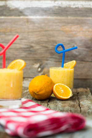 Healthy food, lemon smoothie with lemon fruits on the wooden backgroundの写真素材