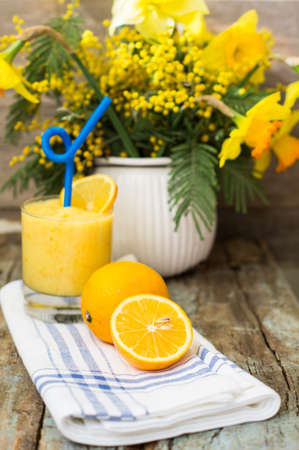 Healthy food, lemon smoothie with lemon fruits on the wooden backgroundの写真素材
