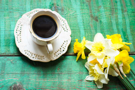 Cup of coffee, easter eggs and bunny on the old wooden tableの写真素材