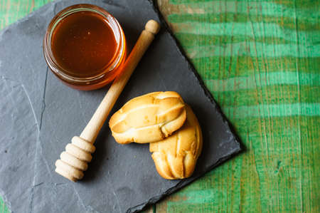 Mug with honey and honeyspoon on the old wooden tabeの写真素材