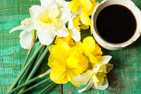 Cup of coffee, easter eggs and bunny on the old wooden tableの写真素材