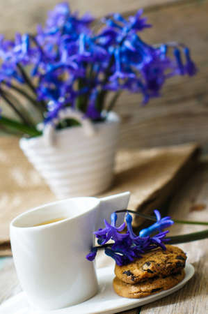 Cup of fresh herbal tea with mint on wooden table
