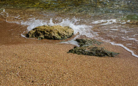 Sand beach of Red sea with rocks and wavesの写真素材