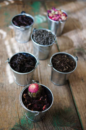 Different types of tea in the metal potsの写真素材