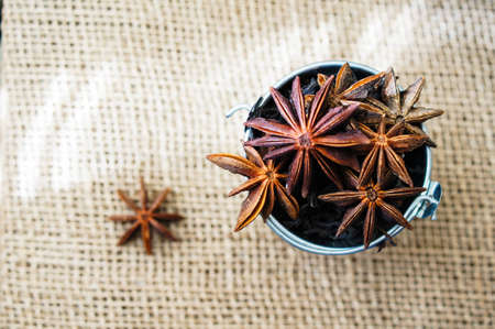 Baking spices on the burlap background, anise starの写真素材