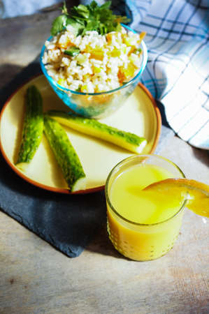 Healthy breakfast with rice and vegetables and orange juiceの写真素材