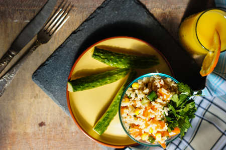 Healthy breakfast with rice and vegetables and orange juiceの写真素材