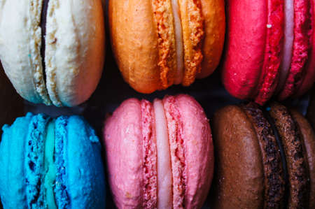 Colorful macaroons on old wooden backgroundの写真素材