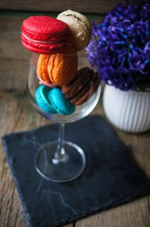 Colorful macaroons on old wooden backgroundの写真素材