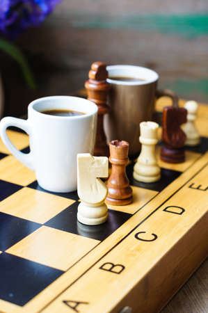 Cup of coffee on the chess board and first spring flowers Scyllaの写真素材