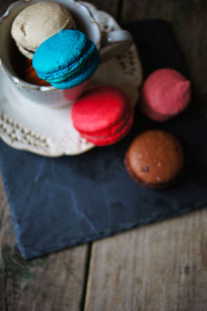 Colorful macaroons on old wooden backgroundの写真素材